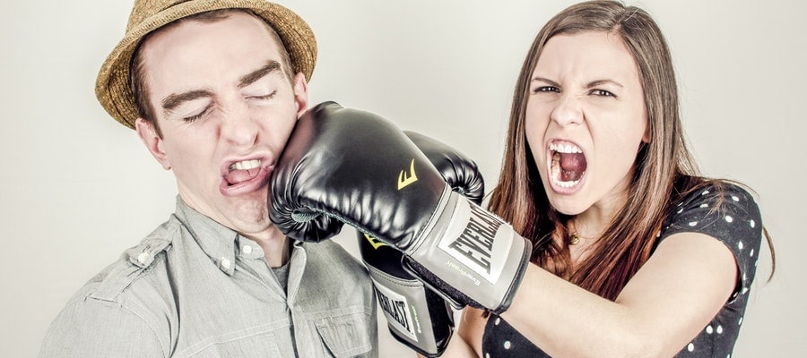 Strong woman punching her husband