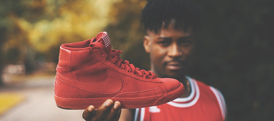 Man holding red Nike shoe